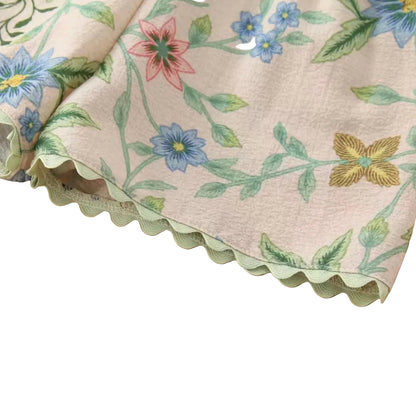 Floral and butterfly patterned fabric on a wooden surface