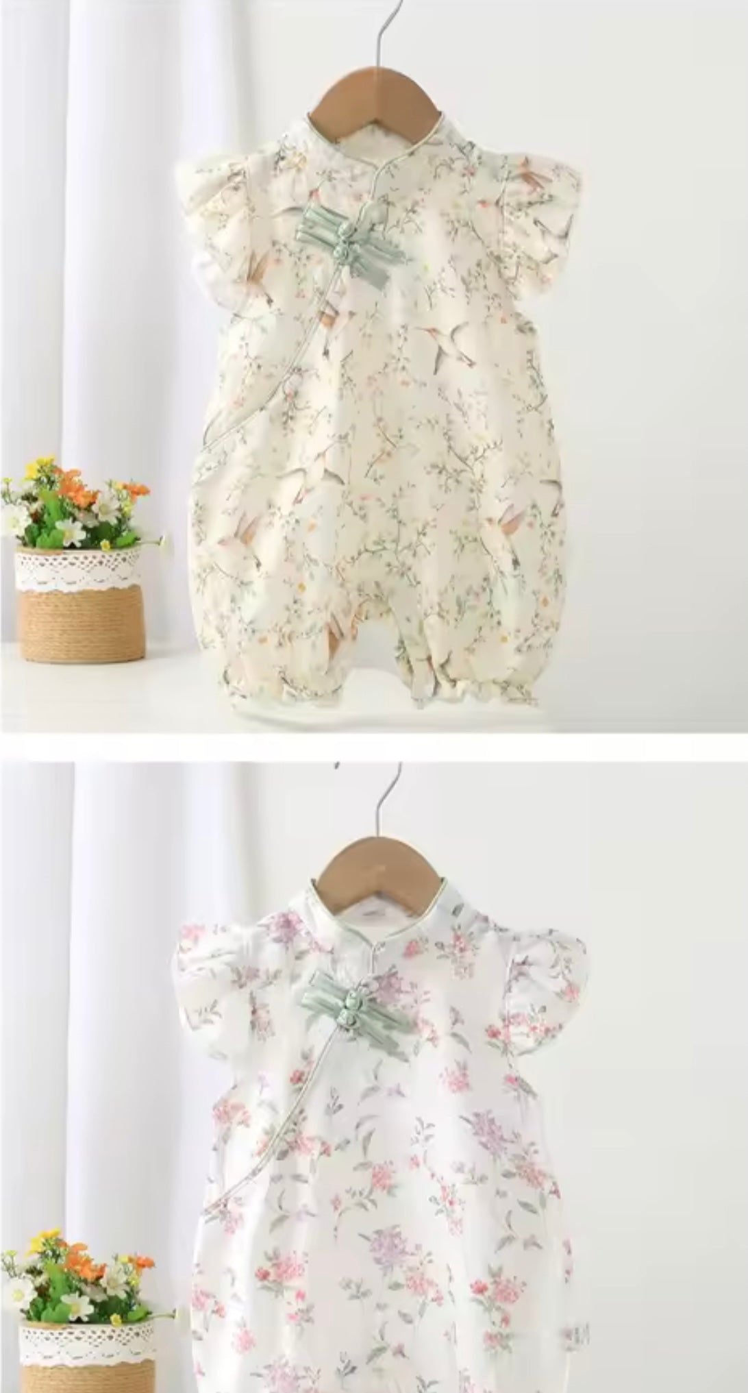 Floral baby romper on a hanger against a white background