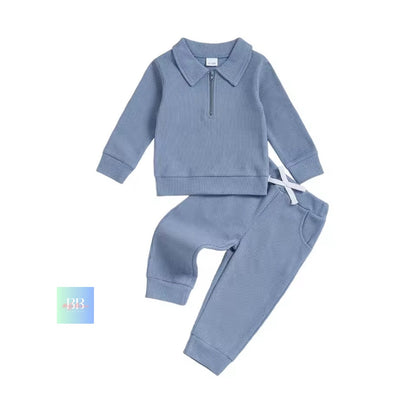 Blue children's outfit with a shirt and pants on a white background