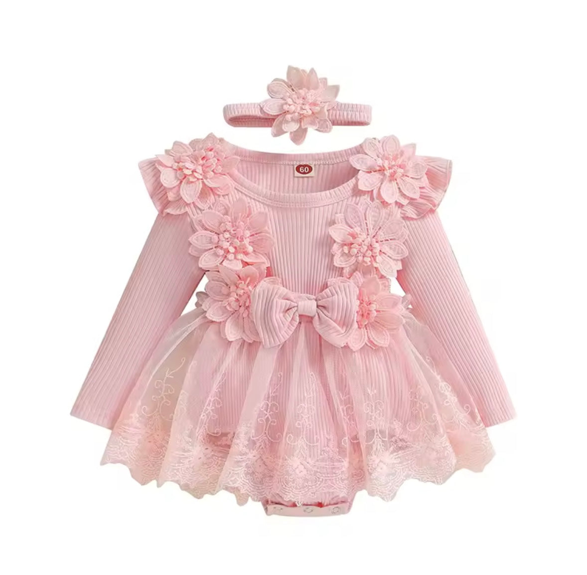 Pink baby dress with floral details and matching headband on a white background