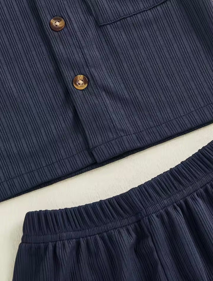 Navy blue pants with button details on a light background
