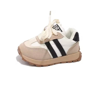 Children's sneaker with beige and white color scheme on a white background