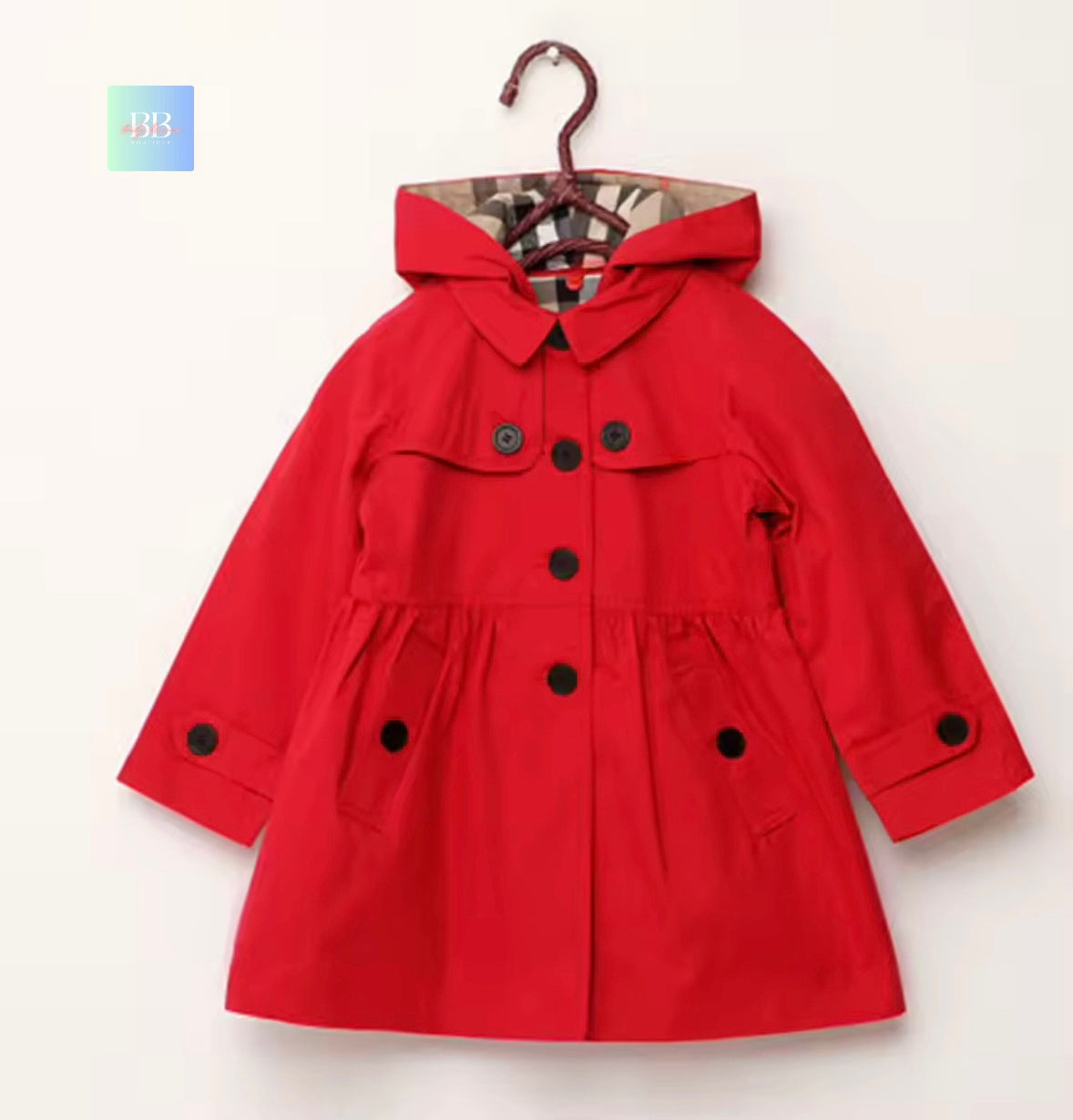 Red children's coat on a hanger against a white background