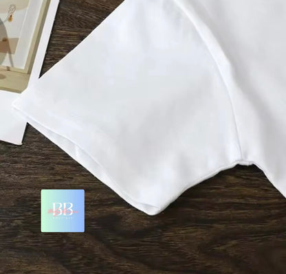 White fabric on a brown surface with a brand logo in the corner.