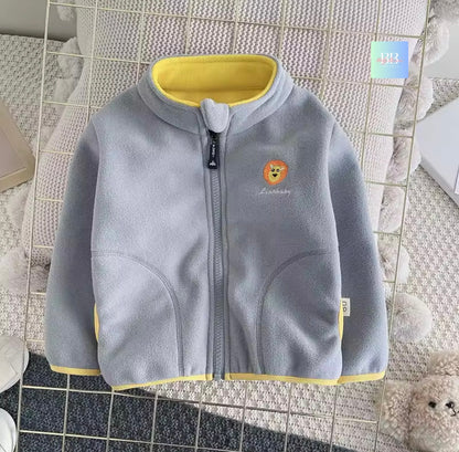 Gray children's jacket with yellow trim on a tiled floor