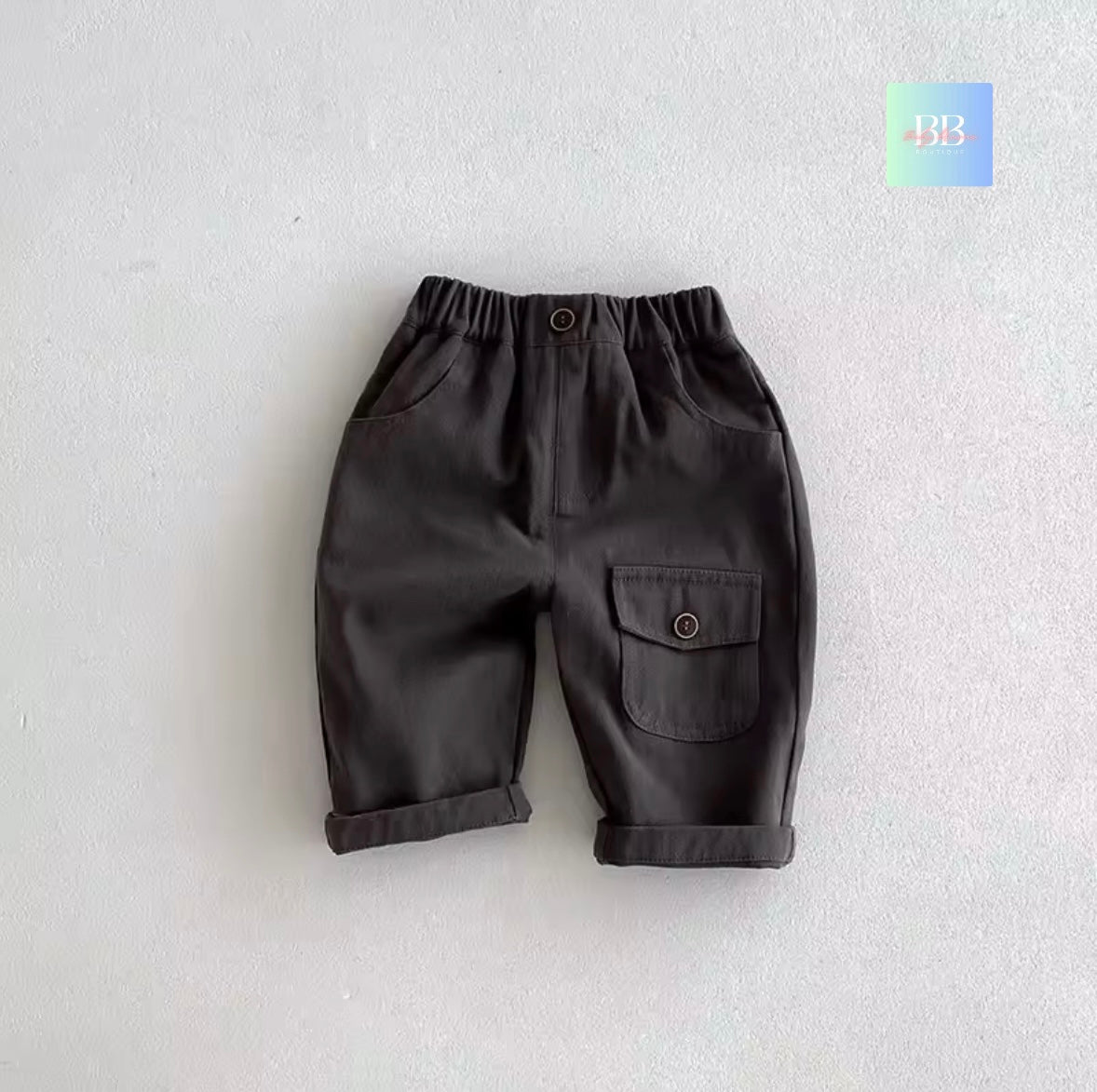 Dark gray children's pants on a light gray background