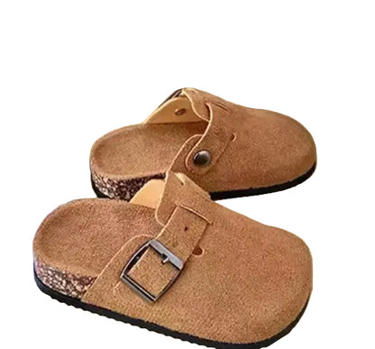Pair of brown clogs with buckles on a light surface.