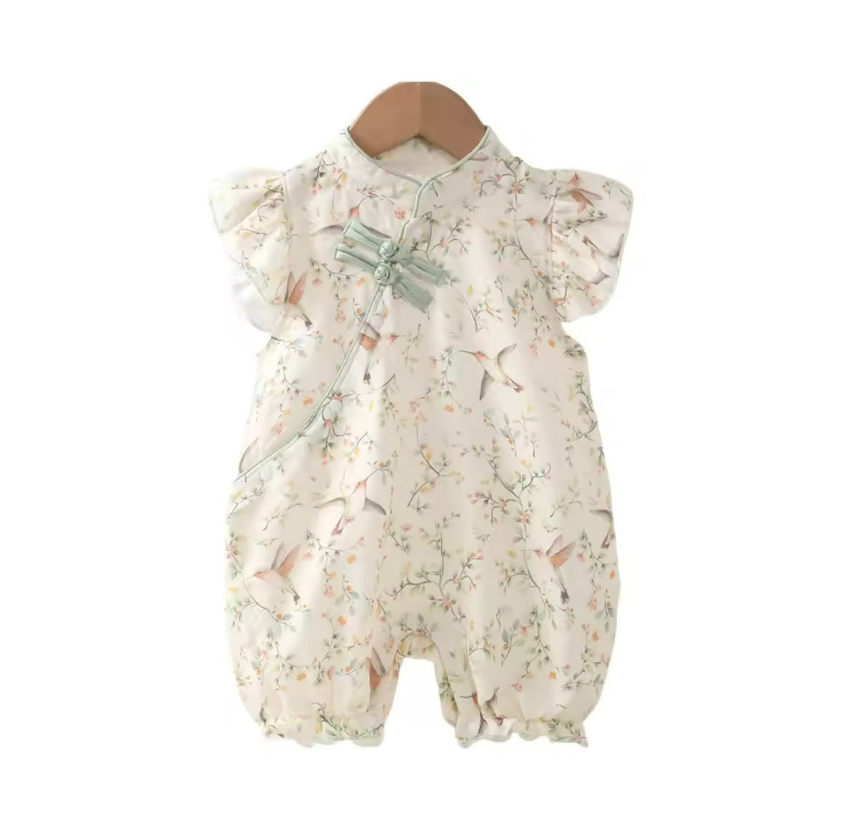 Floral baby romper on a mannequin against a white background