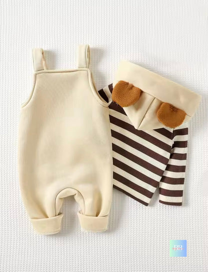 Beige baby romper and striped shirt with bear ears on a textured white background