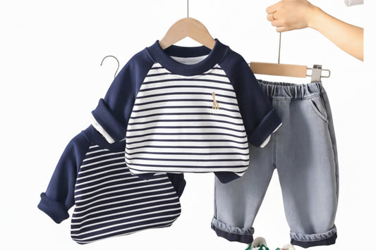 Children's clothing set with striped shirt and pants on a hanger against a light background.