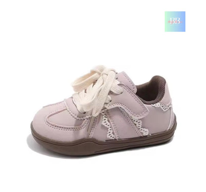 Children's light purple shoe with white laces on a white background