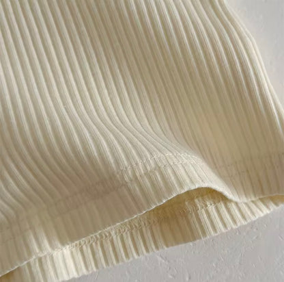 Close-up of beige pleated fabric on a light background