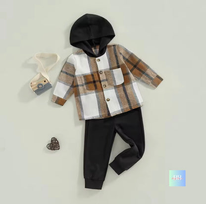 Children's outfit with plaid shirt, black pants, and black hood on a light gray background