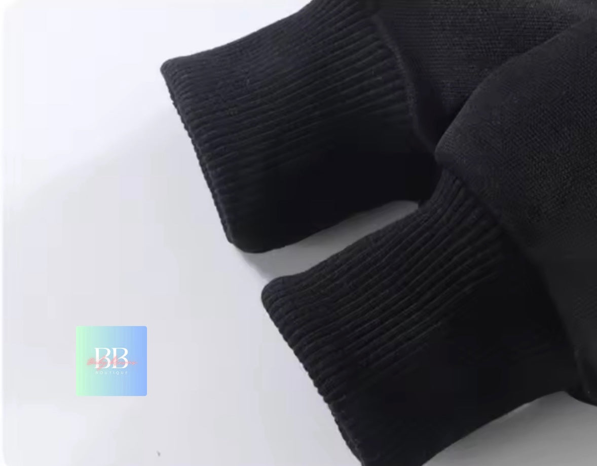 Close-up of black knit gloves on a white background