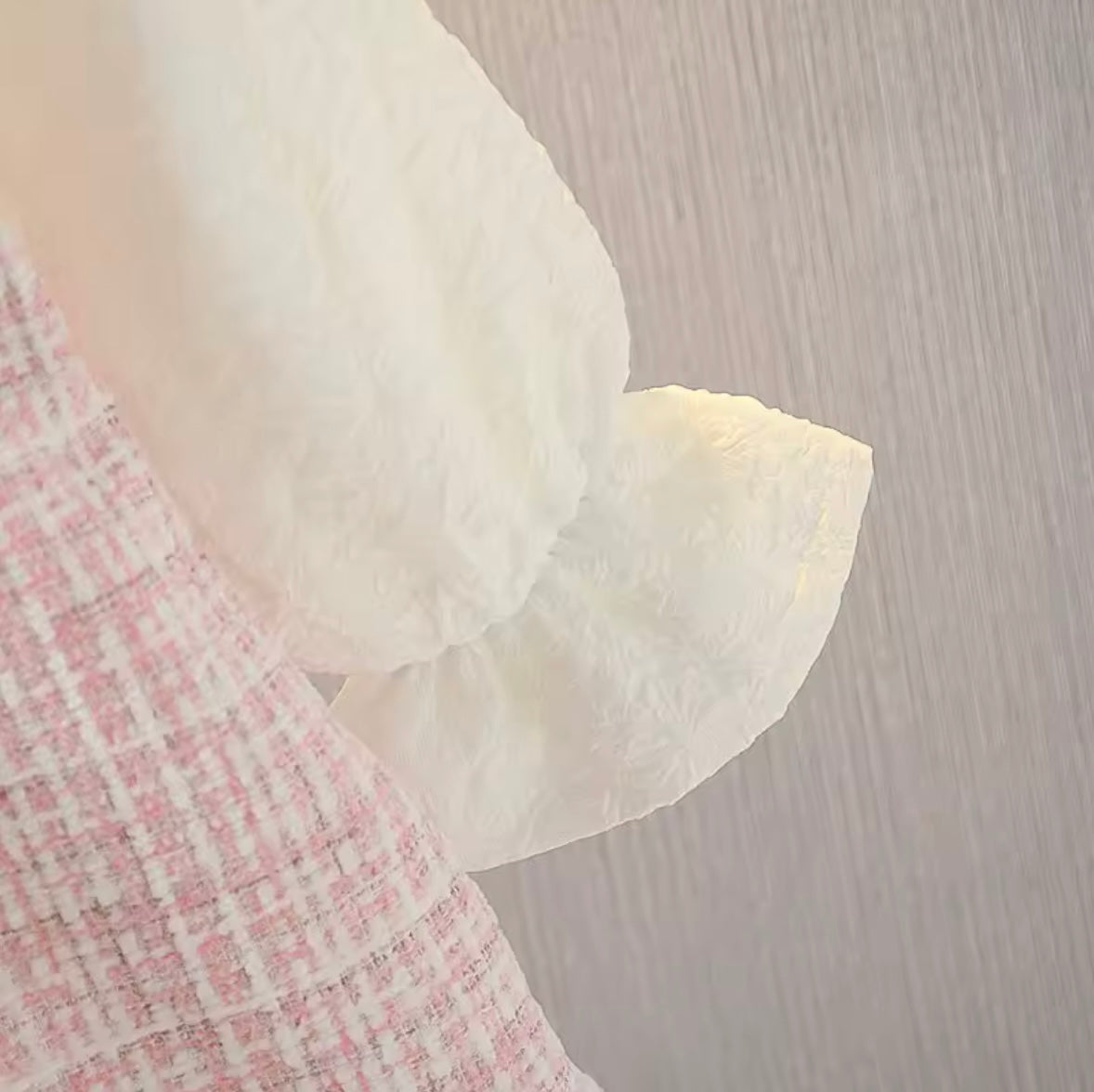 Close-up of a textured fabric with a floral pattern on a neutral background