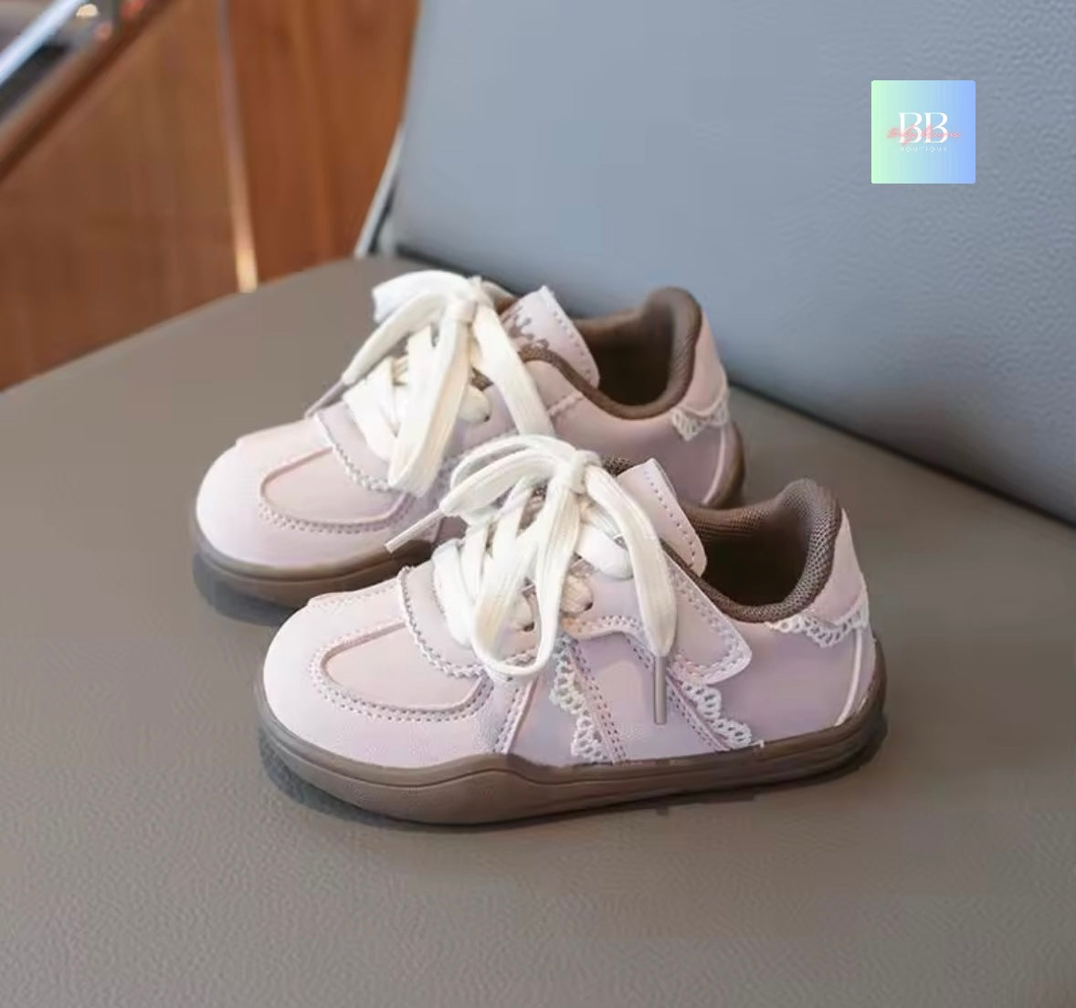 Pair of children's sneakers on a surface with a blurred background