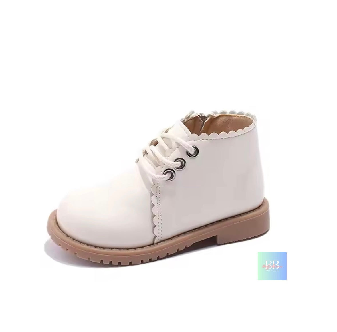 White ankle boot with brown sole on a white background