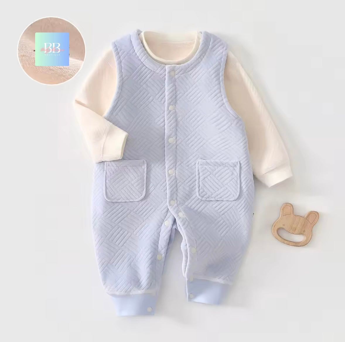 Baby romper with quilted design on a white background