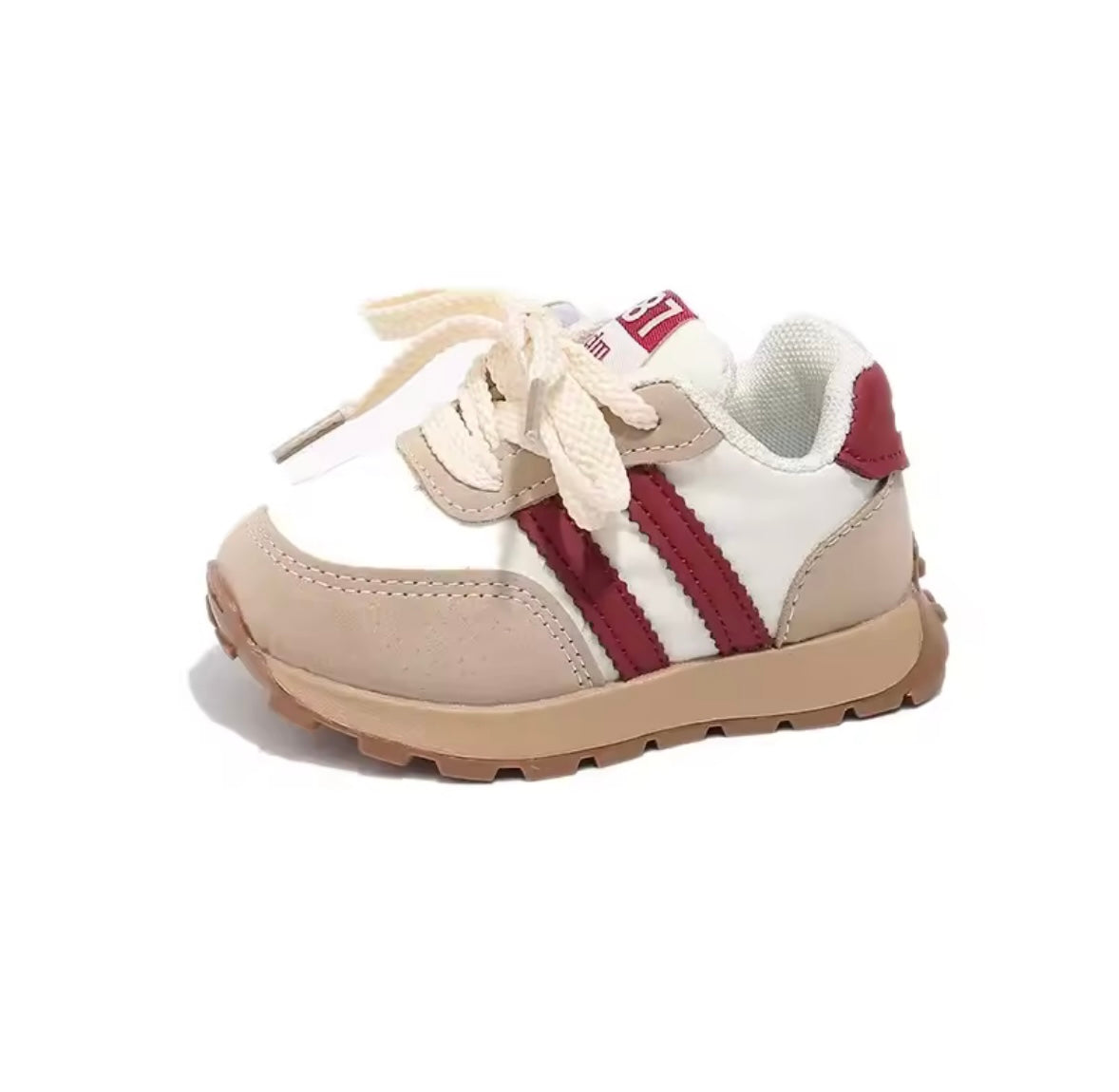 Children's sneaker with white and red design on a white background