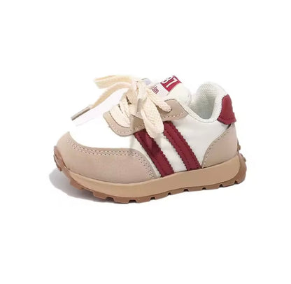 Children's sneaker with white and red design on a white background