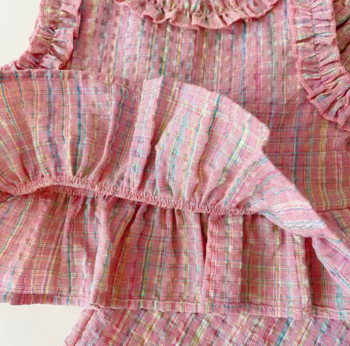 Close-up of a pink plaid fabric with ruffled edges