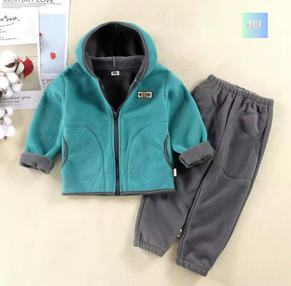 Children's teal jacket and gray pants set on a light background