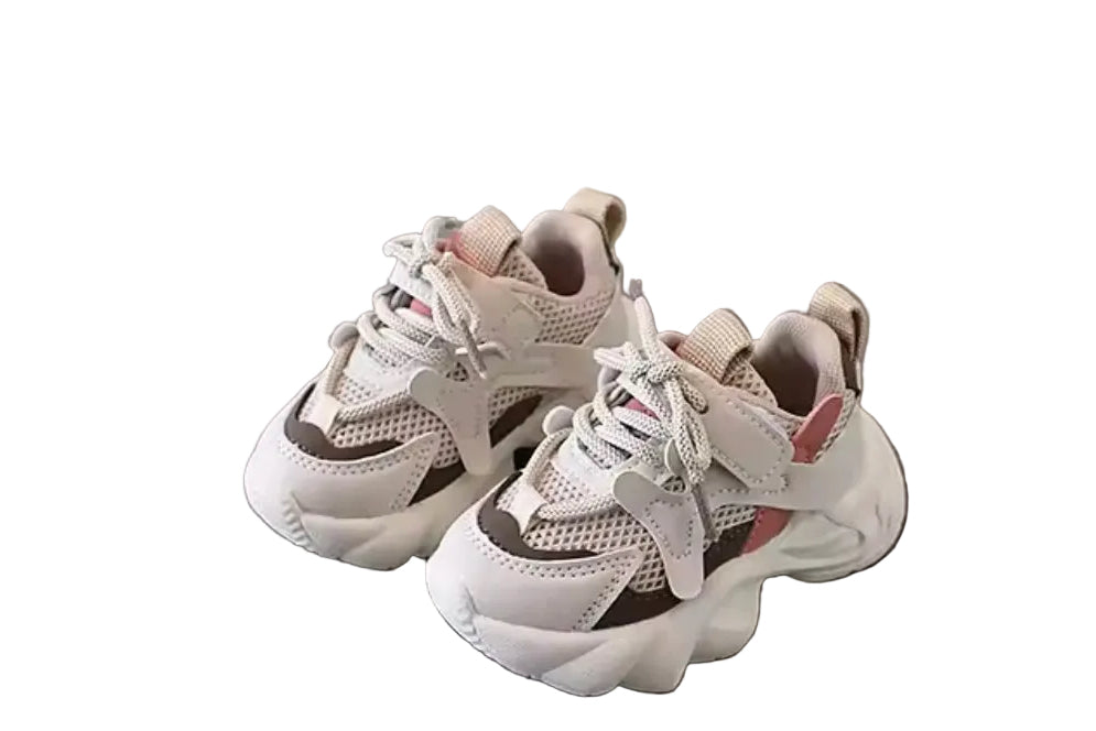 Pair of white sneakers on a gray surface with a white background