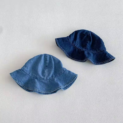 Two denim bucket hats on a light gray background