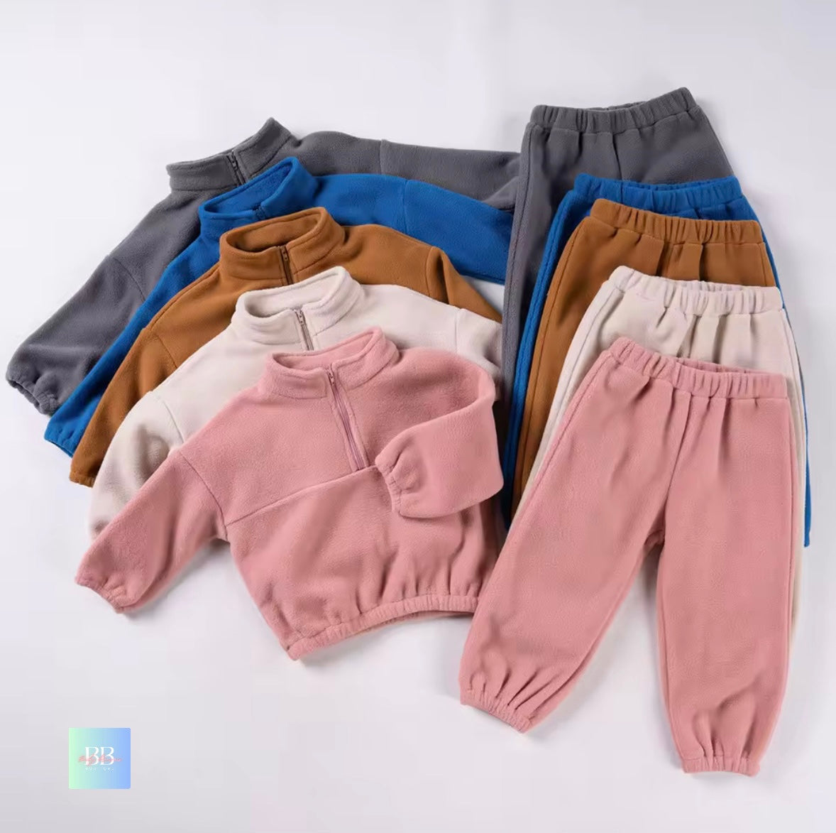 Children's clothing including sweatshirts and pants in various colors on a white background