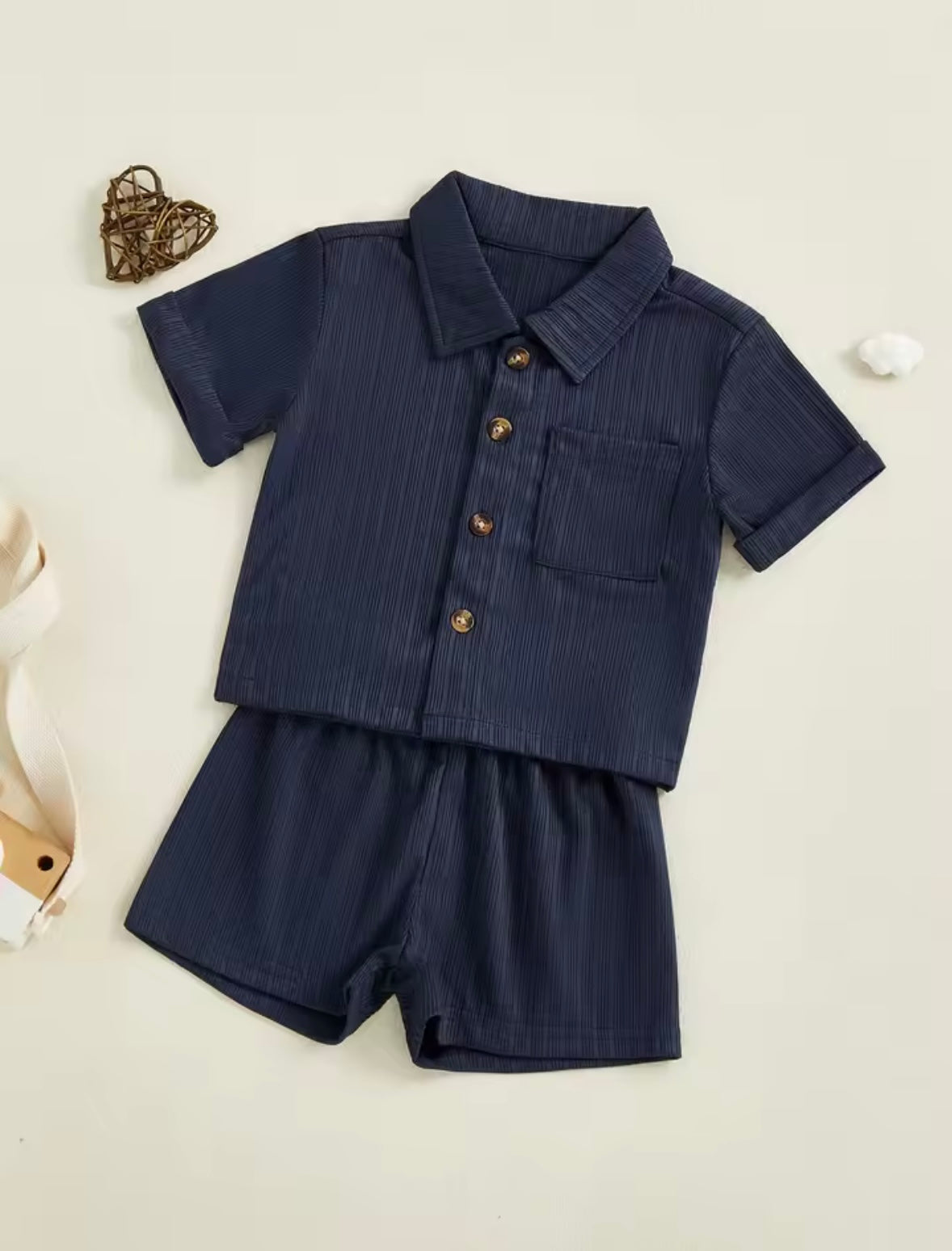 Navy blue children's outfit with a shirt and shorts on a light background