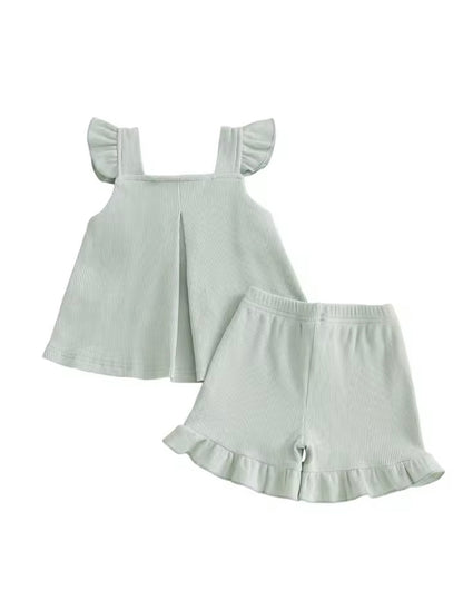 Light green dress and shorts set on a white background
