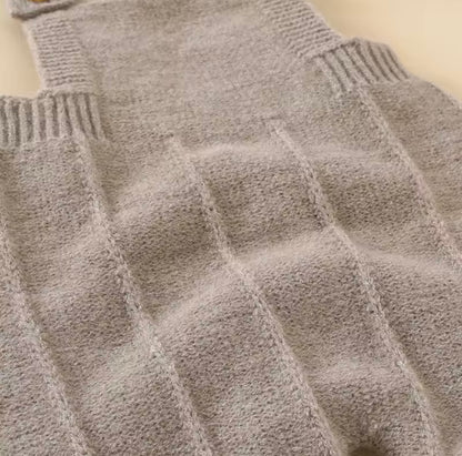 Close-up of a textured gray sweater with a geometric pattern.
