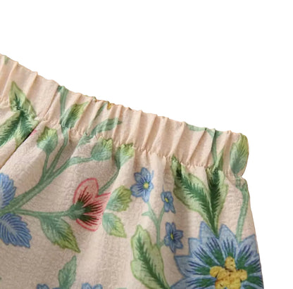 Close-up of floral fabric with a wooden surface background