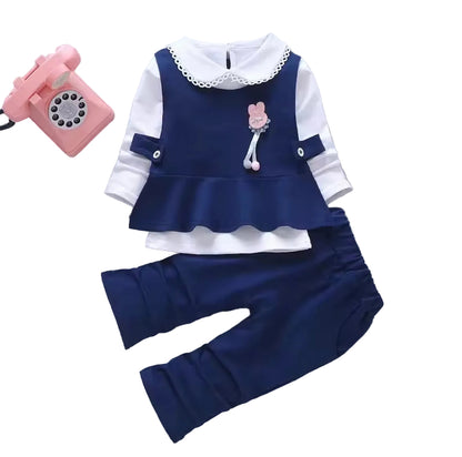 Children's navy blue and white outfit with pink phone on gray background
