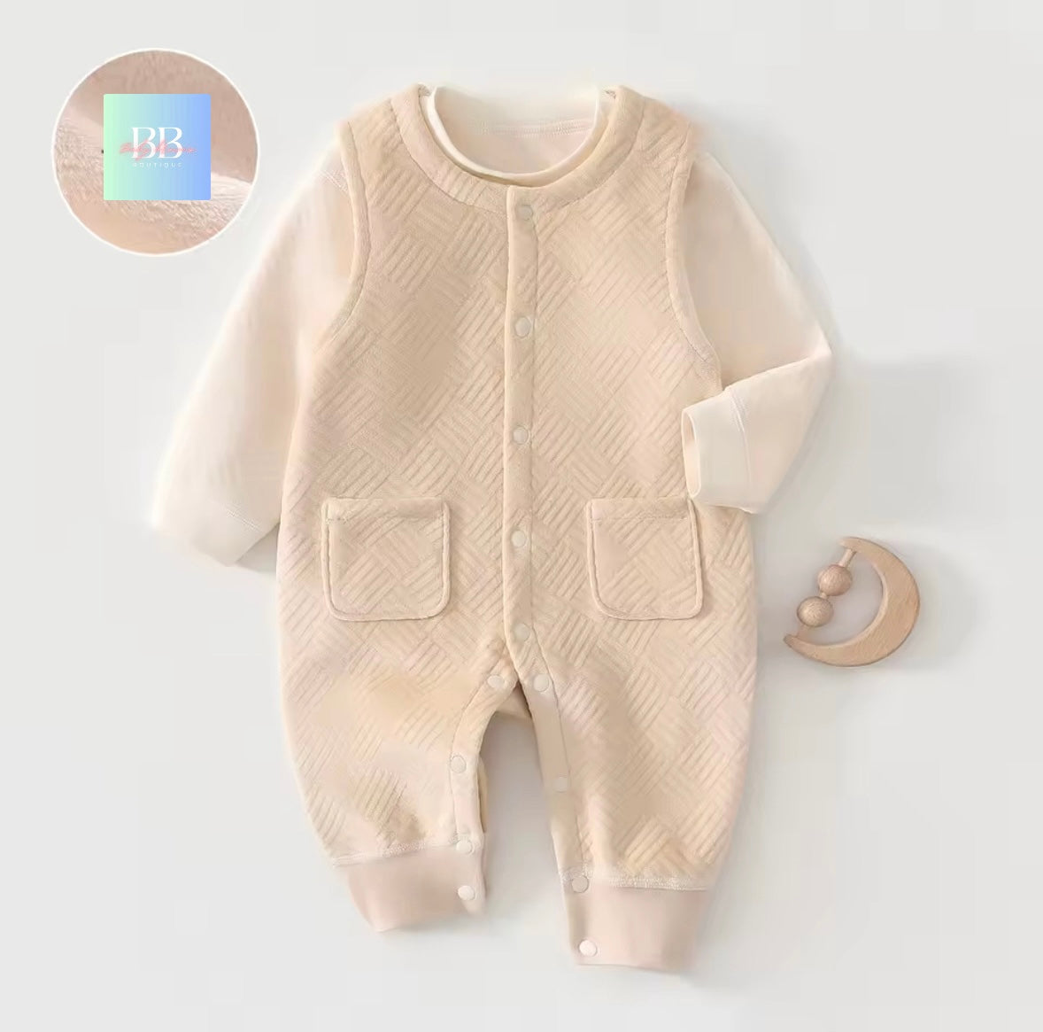 Beige baby onesie with textured pattern on a white background