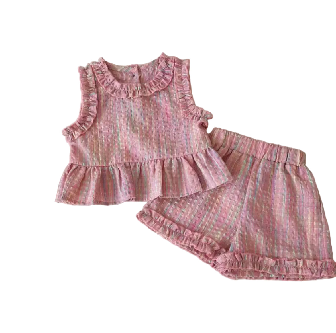 Pink children's outfit with ruffles on a white surface
