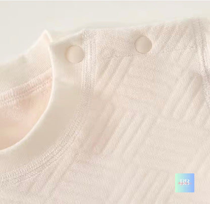 Close-up of a textured white fabric with buttons on a light gray background