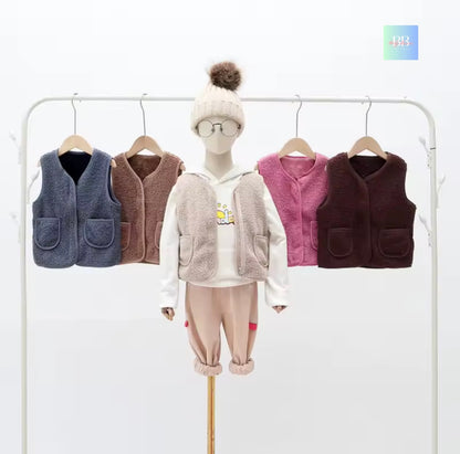 Children's clothing set with vests and a hat on a white background