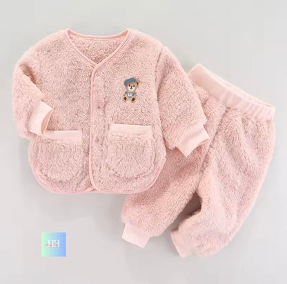Pink baby outfit with a teddy bear design on a light gray background