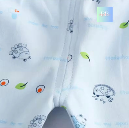 Close-up of white fabric with colorful embroidered designs on a white background.