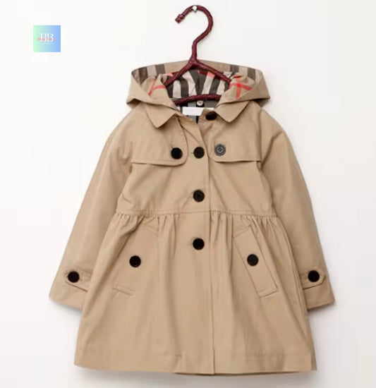 Children's beige trench coat with black buttons on a white background