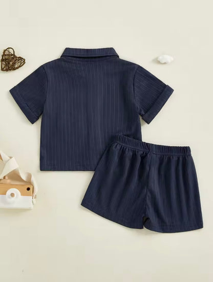 Navy blue shirt and shorts set on a light beige background
