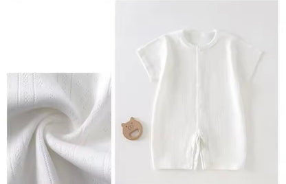 White baby outfit with fabric swatch on a light gray background