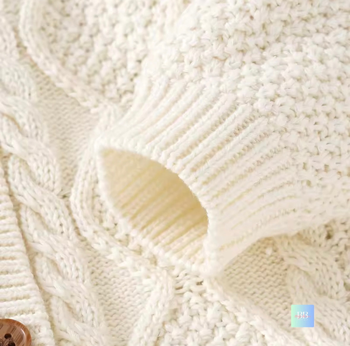 Close-up of a textured white fabric with a button in the corner