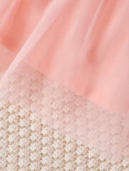 Close-up of pink fabric with a textured beige border