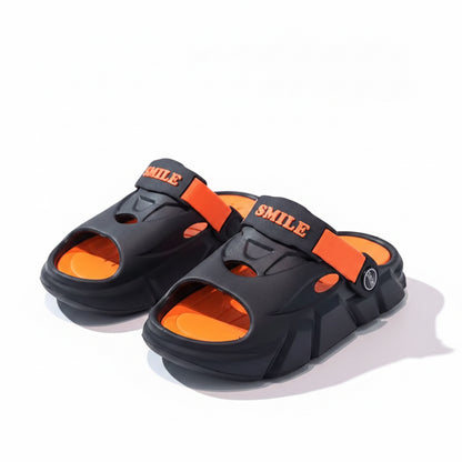 Black and orange sandals with 'SMLN' branding on a reflective surface.