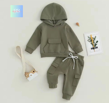 Green hoodie and pants set on a light gray background with a plant-themed card and strap.