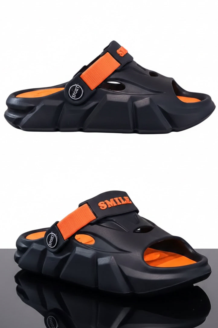 Black and orange sandals on a reflective surface with a neutral background