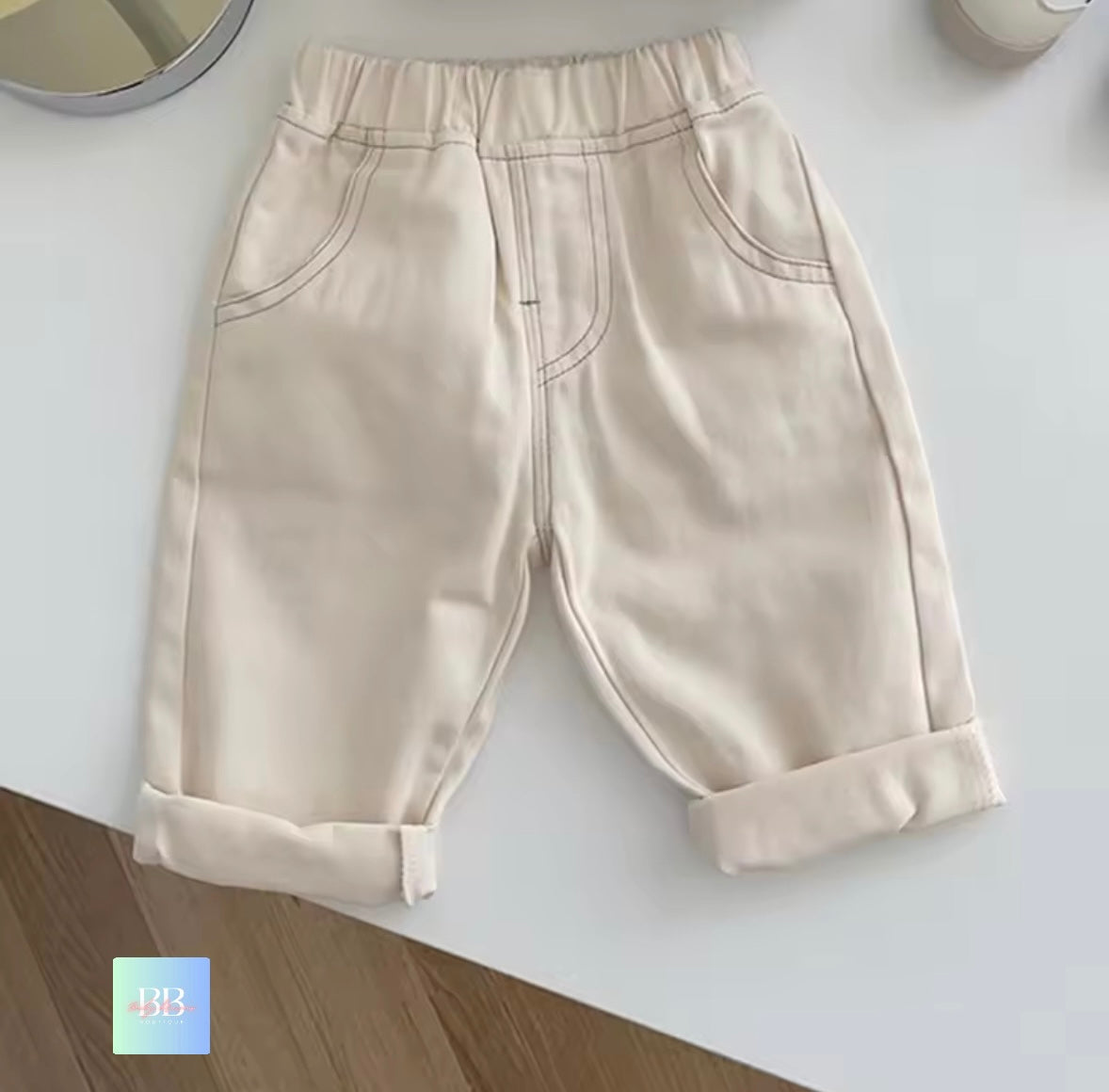 Beige pants on a white surface