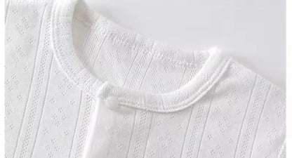 Close-up of a white textured garment with a collar